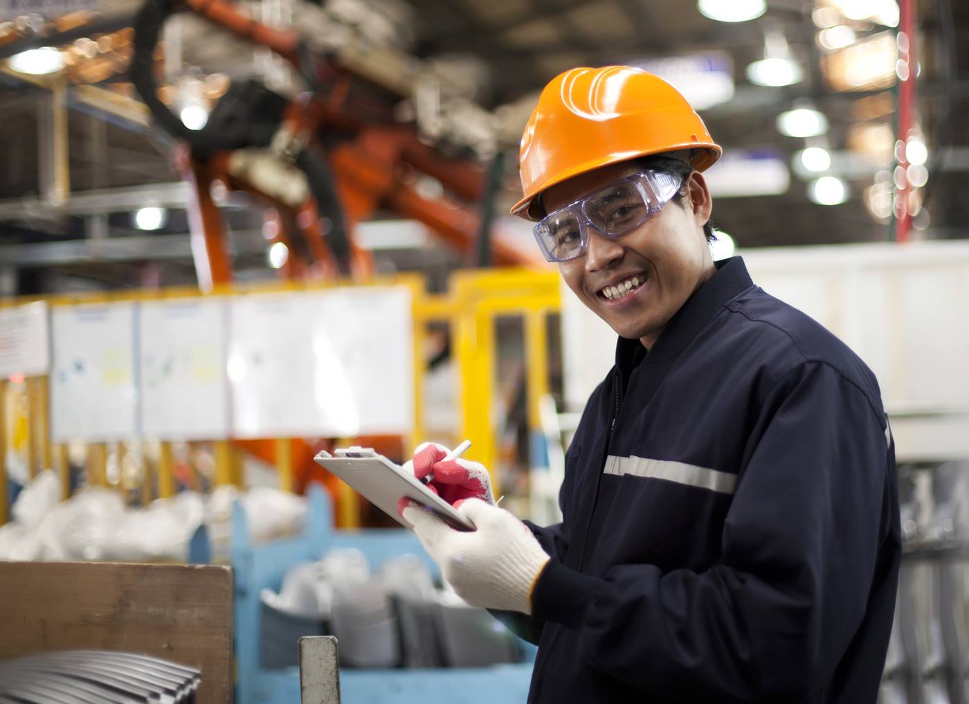 Engineer at a plant writing down some notes