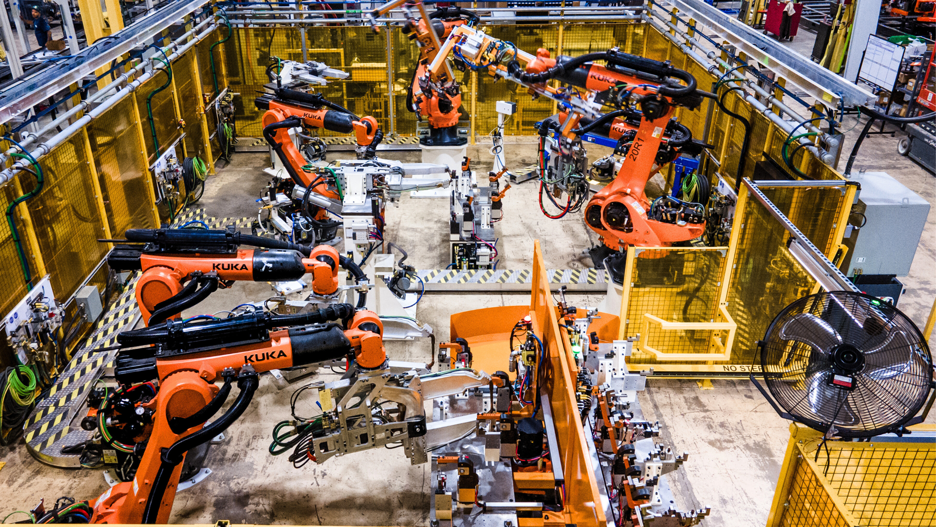 Automotive manufacturing cell with KUKA industrial robots