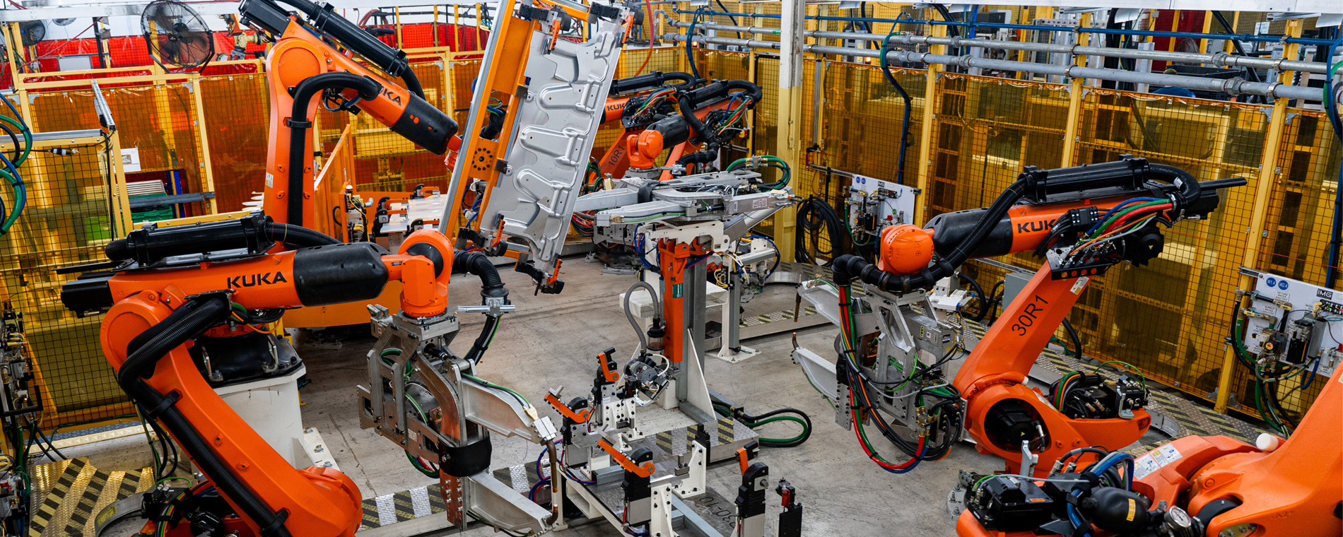 Automotive manufacturing cell with KUKA industrial robots